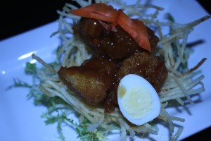 Red Team: Crispy orange chicken in a potato basket, frisee salad and quail egg